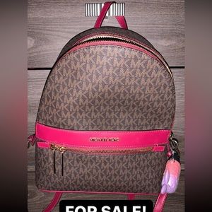 Brown MK backpack with magenta detail in the band and straps!